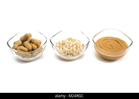 Three glass bowls with nuts ant peanut butter isolated on white. Stock Photo