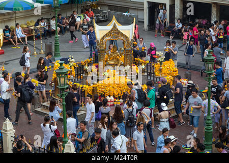 A lot of people at the Erawan Shrine. It's a Hindu shrine and a popular worship and tourist attraction in Bangkok, Thailand. Stock Photo