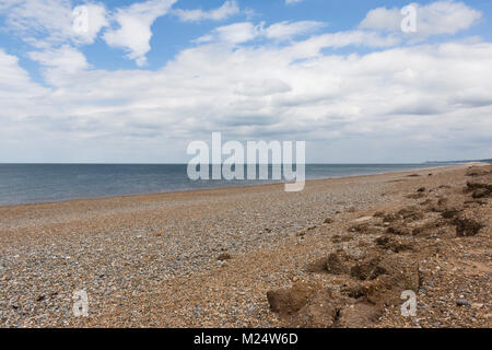 An image showing the effects of Coastal Erosion on a stony beach in Norfolk, England, UK Stock Photo