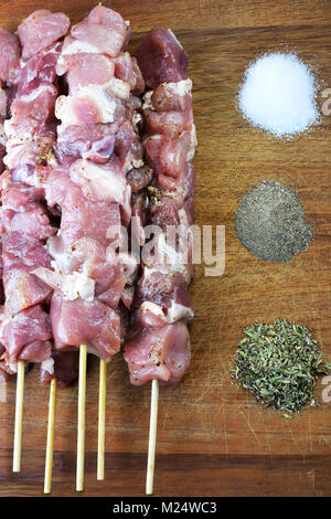 Raw souvlaki with spices on a wooden board Stock Photo
