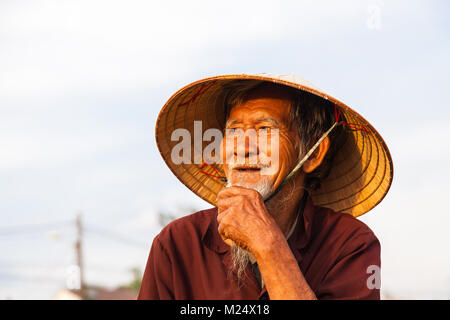 Old farmer on a vegetable farm outside Hoi An,  central Vietnam. Stock Photo