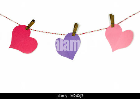colorful paper hearts and clothespins on red and white striped string isolated on white Stock Photo