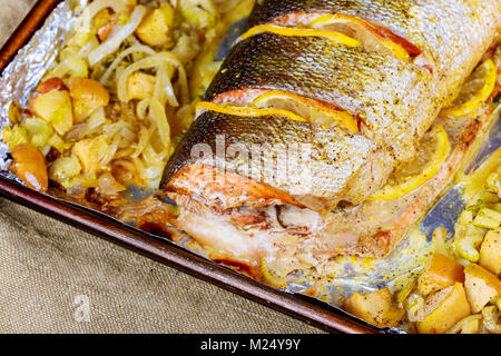 Baked salmon in an oven with different spices Salmon fillets baked in oven served with vegetables Stock Photo