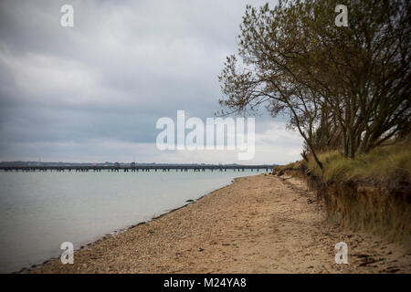 The beach at Hamble-le-Rice with the Oil Terminal Jetty in the distance Stock Photo