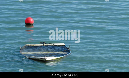 horizontal view of a small wooden boat sunken in the sea Stock Photo