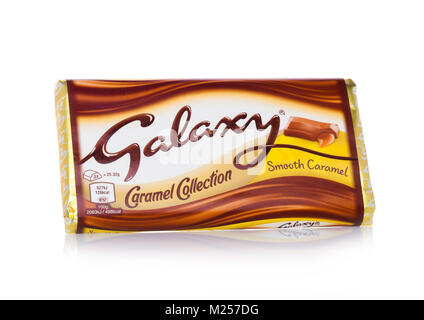 LONDON, UK - FEBRUARY 02, 2018: An unopened Galaxy chocolate bar with smooth caramel on white background.Manufactured by Mars Stock Photo