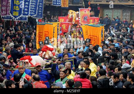 (180205) -- BEIJING, Feb. 5, 2018 (Xinhua) -- File photo taken on Dec. 19, 2009 shows people taking part in a traditional parade in Shangli Ancient Town of Ya'an, southwest China's Sichuan Province. In Chinese villages, people have their distinctive ways to celebrate the Spring Festival. Simple but joyful, the celebrations bring them gratification and happiness. Spring festival, or better known as Chinese Lunar New year, is the most important festival for all Chinese, which has a history of more than 4,000 years. It is an occasion for home returning, New Year goods preparing, celebrating, and Stock Photo