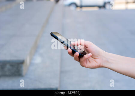Woman holding smartphone with blank screen Stock Photo