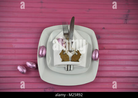 Easter time table place setting with chocolate Easter eggs and decorations Stock Photo