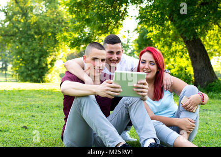 Group of students using digital tablet Stock Photo