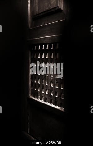 A church confessional booth wooden partition screen Stock Photo - Alamy