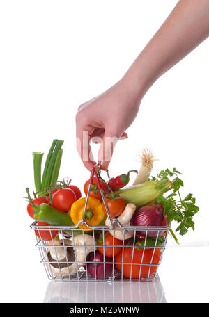 Raw vegetables and hand  in basket isolated on white Stock Photo