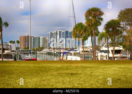 Boats in the harbor with waterfront apartments overlooking the marina in Sarasota FL, USA Stock Photo