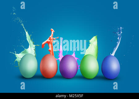 Colorful eggs with splashing paint Stock Photo