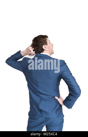 A man in a suit looks up and right whilst scratching his head and thinking about something. View from his back isolated on white Stock Photo