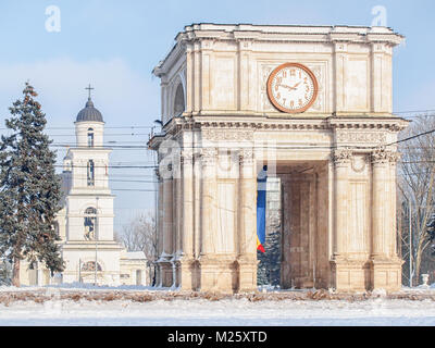 Triumphal arch in the center of Chisinau, Moldova in a sunny winter day. The Chisinau Belfry can be seen behind it Stock Photo