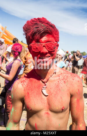 Cosmos Village, Almaty Province, Kazakhstan - 16 August 2015: The festival of ethnic music Forey, a lot of people gathers on this holiday to relax and have  fun. Ethnic open-air concert, where many people gathered. Portrait of a young smiling man on holi color festival Stock Photo