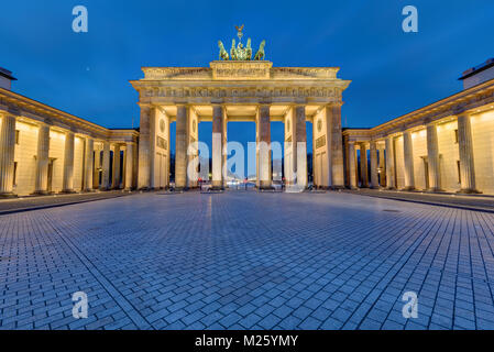 The famous Brandenburg Gate in Berlin illuminated in the early morning Stock Photo