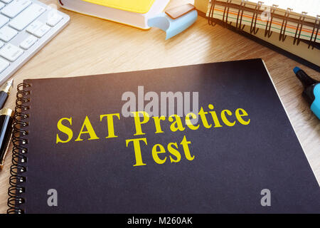 SAT Practice Tests with textbooks on a desk. Stock Photo