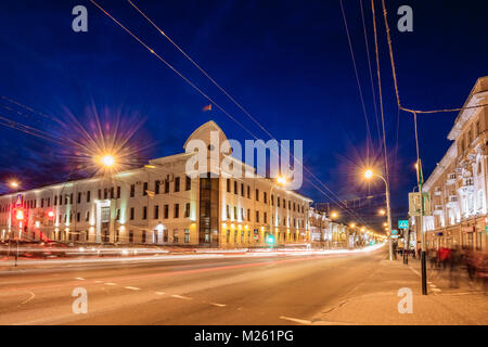 Soviet street in the city of Gomel with traces of cars on long exposure. Night cityscape Stock Photo
