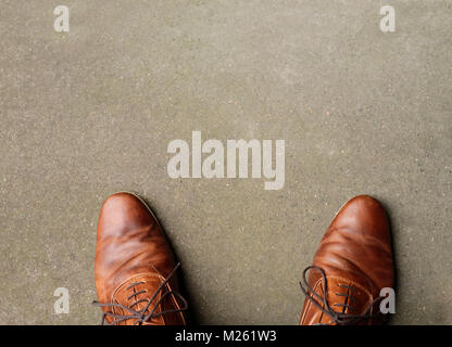 Pair of brown shoes on concrete floor and copy space Stock Photo