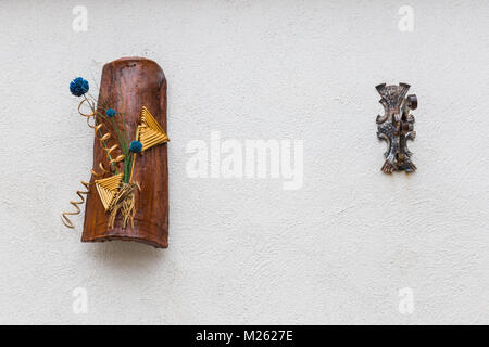 Villetta Barrea, Abruzzo, Italy. October 13, 2017. Artistic decorations attached to the wall of a dwelling Stock Photo