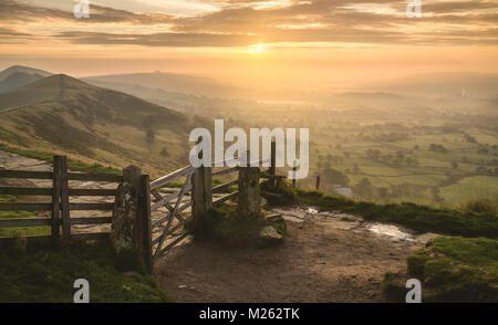 A colourful Sunrise at the famous gate on Mam Tor in the Peak District, Derbyshire UK Stock Photo