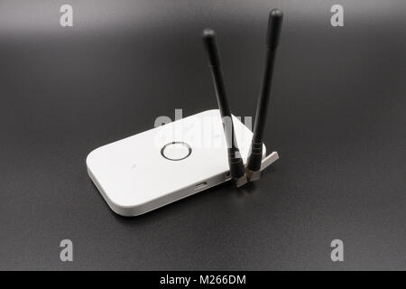 Wi-Fi portable router with connected external antennas. On a black background. Stock Photo