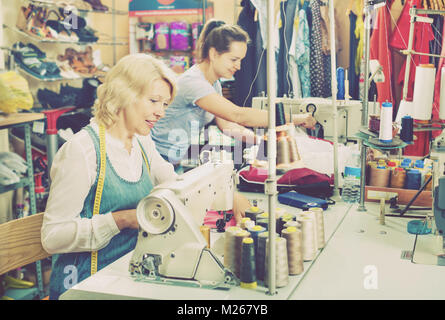 Portrait of two professional experienced female tailors working in a sewing workshop Stock Photo