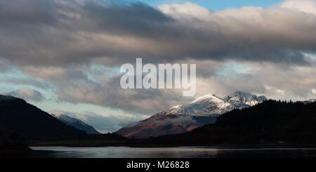 Garbh-Bheinn of Ardgour rises majestically behind the Ballachulish bridge, as seen from Glencoe village on a cold December morning. Stock Photo
