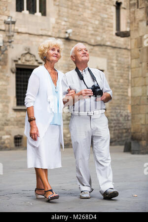 Senior main with his wife photographing sights during walk around city Stock Photo