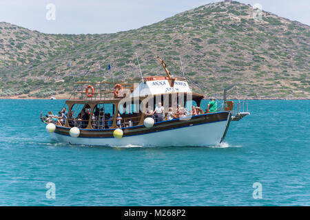 Excursion boat returning from Spinalonga, Elounda, Lasithi Region, Crete (Kriti), Greece Stock Photo