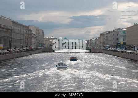 SAINT-PETERSBURG, RUSSIA - AUGUST 17, 2013: Boats on the Fontanka River. On the background is the Trinity Cathedral Dome Stock Photo