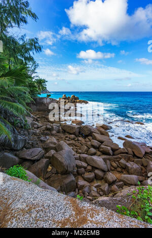 Big granite rocks, palm trees, turquoise water of the indian ocean ...