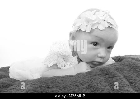 11 week old baby girl exploring on soft plat in the nursery Stock Photo