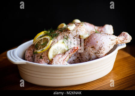 Raw chicken marinated with spices in a baking dish Stock Photo