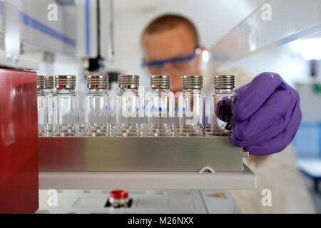 Chemical laboratory man manipulating some flasks