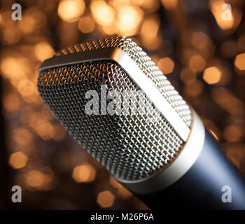 Microphone with a silver head with a tan and orange background Stock Photo