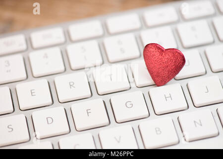 Small red heart on keyboard internet dating concept, Valentine Day Stock Photo