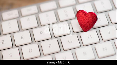 Small red heart on keyboard internet dating concept, Valentine Day Stock Photo