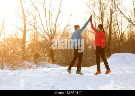 Picture of young sportsmen doing handshake in winter park at afternoon Stock Photo