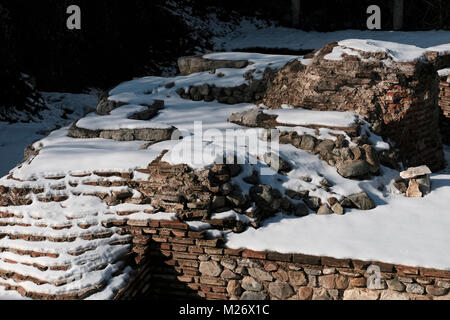 Snow covers remains of the western gate of the Roman city, Serdica, that once occupied this area and were unearthed from 2010 to 2012 during construction of the metro in the city of Sofia capital of Bulgaria. Stock Photo