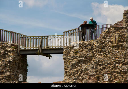 A couple look at an information board on the walls of Framlingham castle Stock Photo