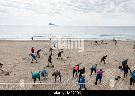 Seniors keeping fit on the beach in Benidorm, Spain. Men women oap's, elderly fitness class Stock Photo