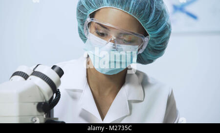 Lab researcher working on microscope at university laboratory, close-up Stock Photo