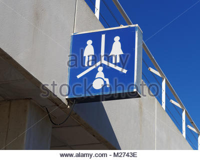 Public convenience sign with male and female symbols and direction