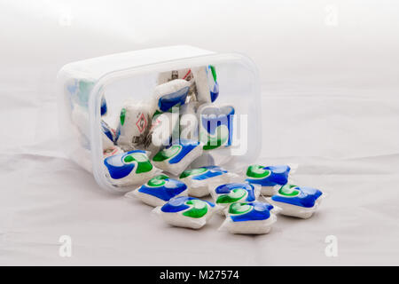 Largs, Scotland, UK - February 03, 2018: Spilled box of Persil Dishwasher Tablets on White Linen Table Cloth. Stock Photo