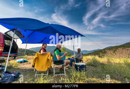 Middle aged campers at Brewer Creek Forest Service Road, Purcell Mountains, near Invermere, British Columbia, Canada Stock Photo