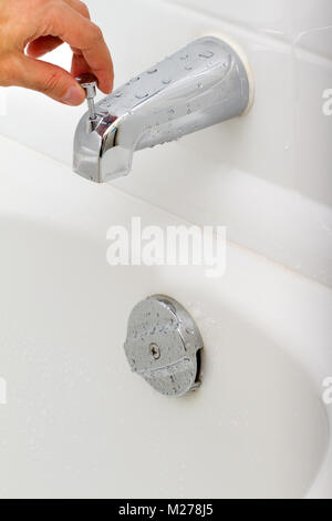 Demonstration of how the water tap is working in a bathroom Stock Photo