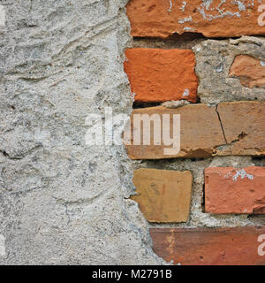 Red bricks stone wall background closeup, cracked ruined stucco, vertical plastered grunge grey beige stonewall limestone pattern, old aged weathered  Stock Photo